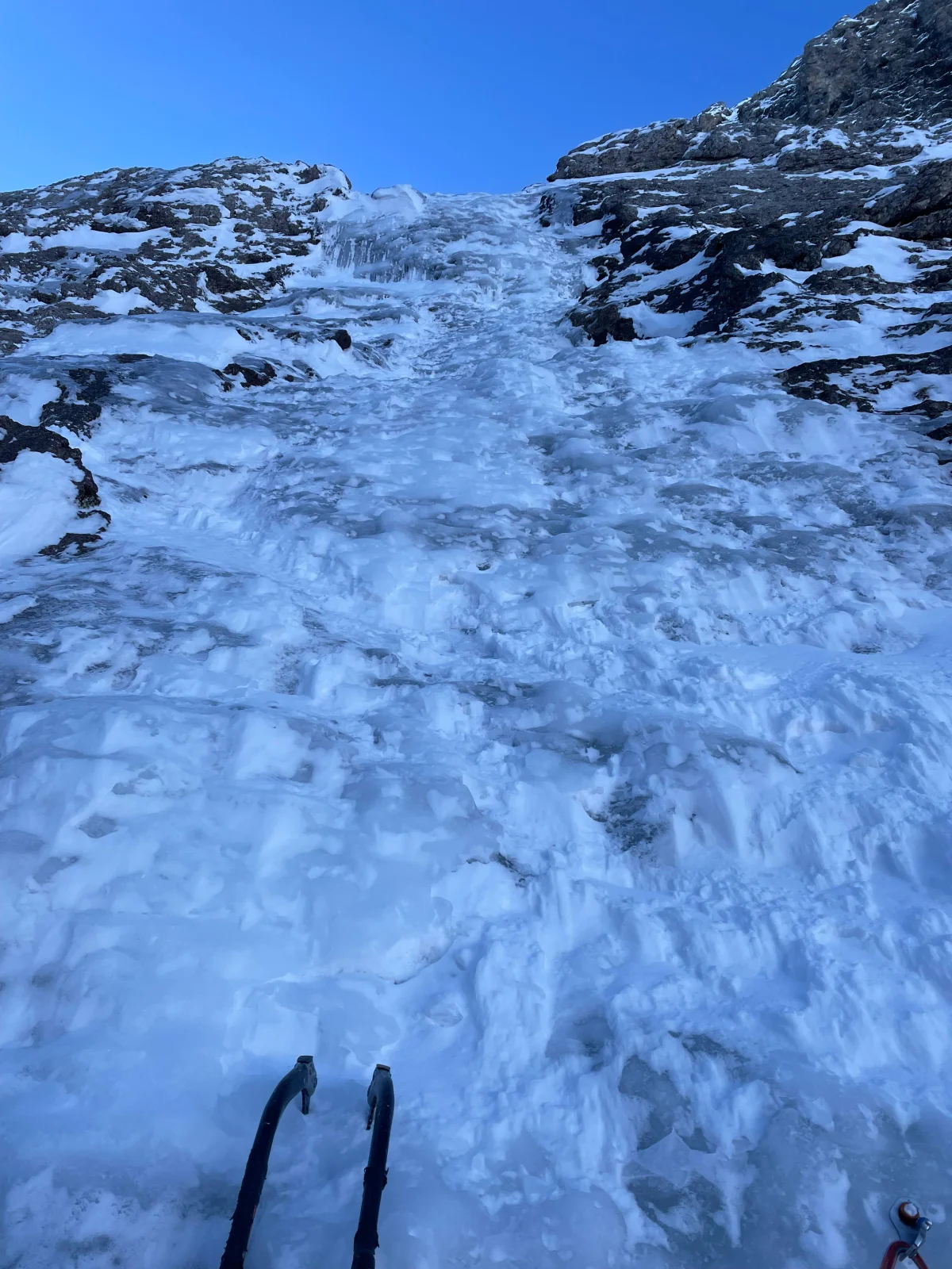 Beginner-Friendly Ice Climbing Tour in the Dolomites: Ice tools in front of a stepped ice wall.