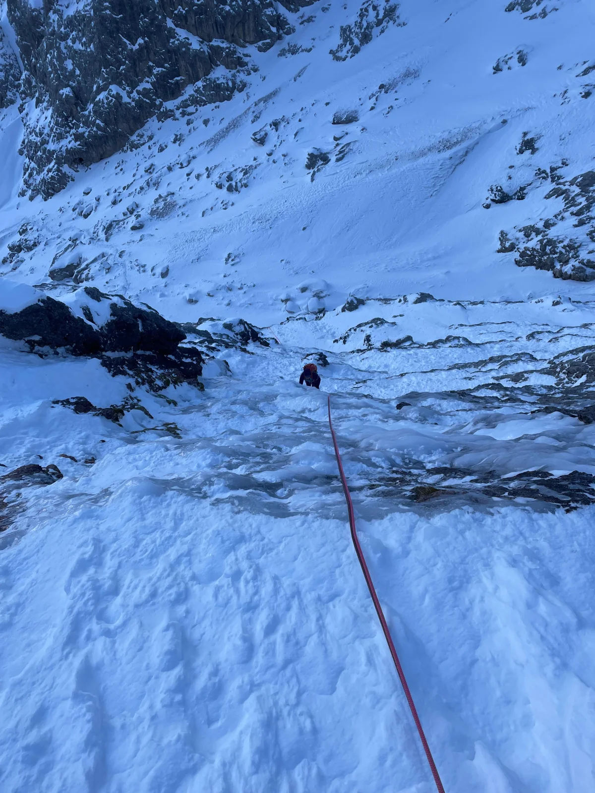 Beginner-Friendly Ice Climbing Tour in the Dolomites: Roped climbing route over icy rock steps.