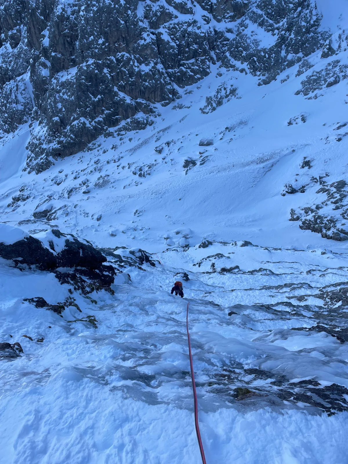 Beginner-Friendly Ice Climbing Tour in the Dolomites: Roped climbing route over icy rock steps.
