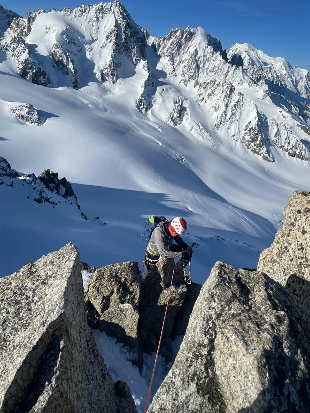 Arête de la Table on Aiguille du Tour: Mountaineer between granite towers with a glacier behind.