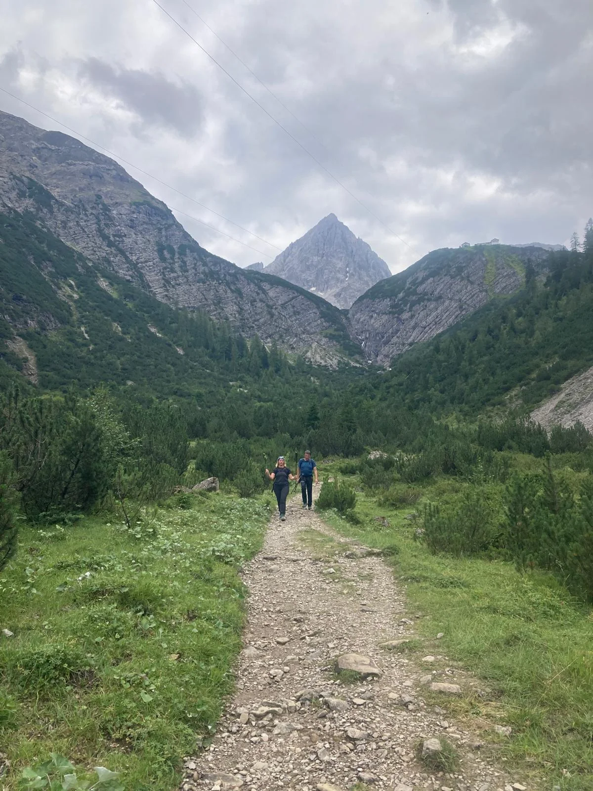 Dremelspitze – One of the Most Beautiful Peaks in the Lech Valley: Hikers on a mountain path between green slopes.