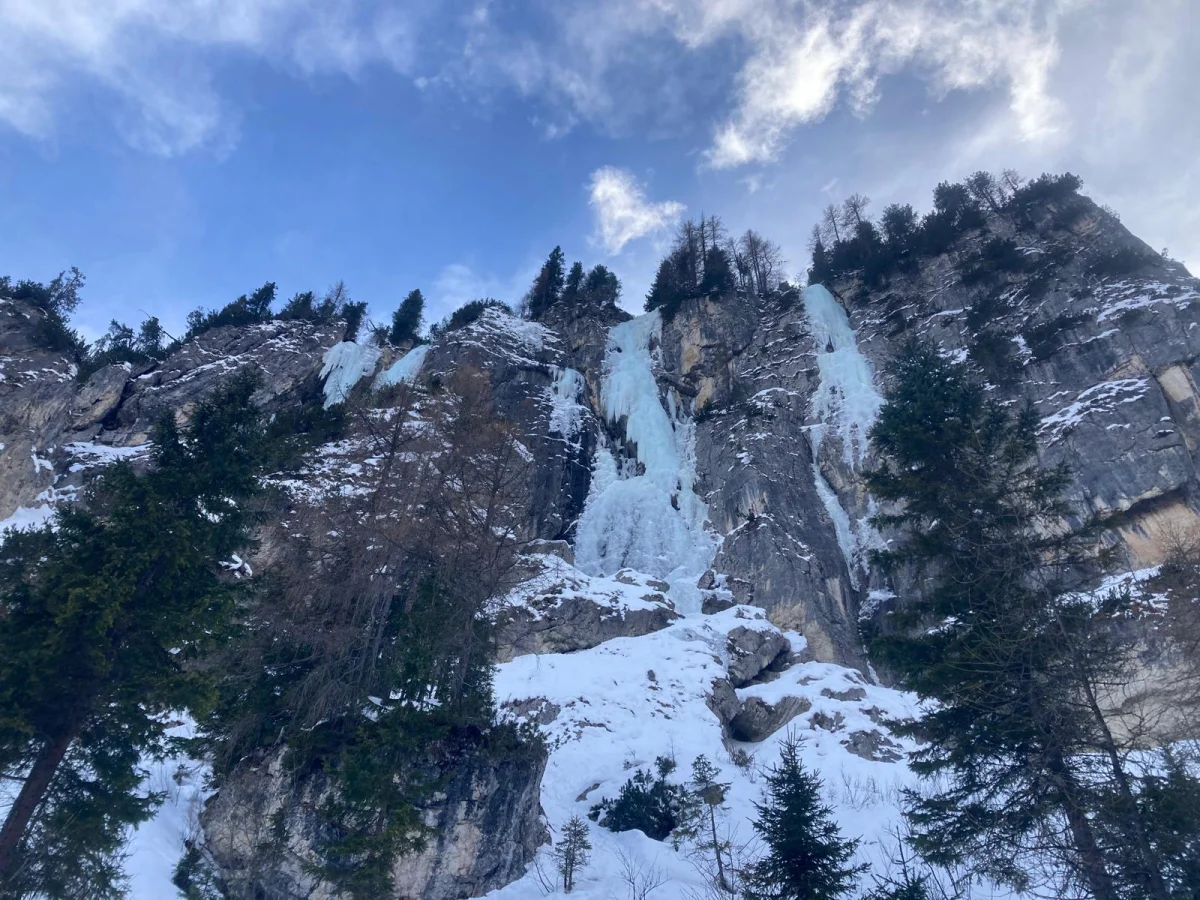 Ice Climbing in Colfosco with a Mountain Guide: Frozen waterfall in a snow-covered rock wall.