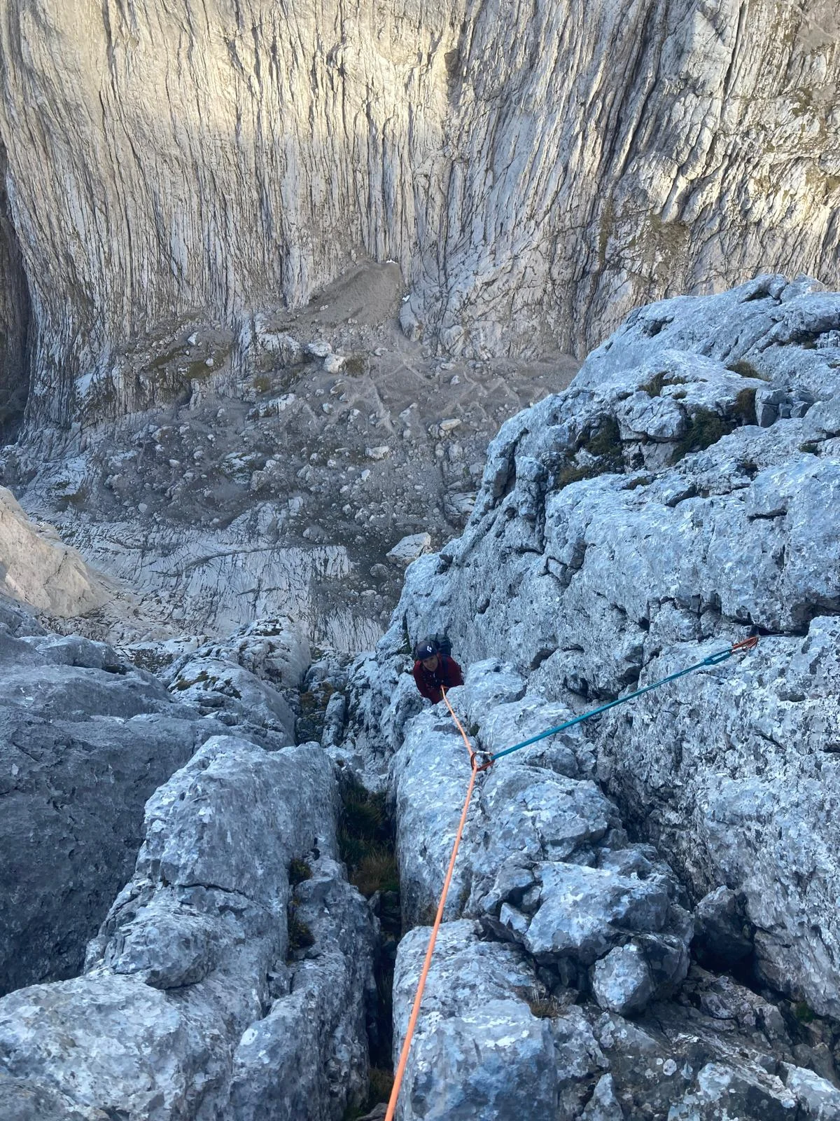 Fleischbank East Face – Dülfer Route: Following climber in a rocky exit gully.