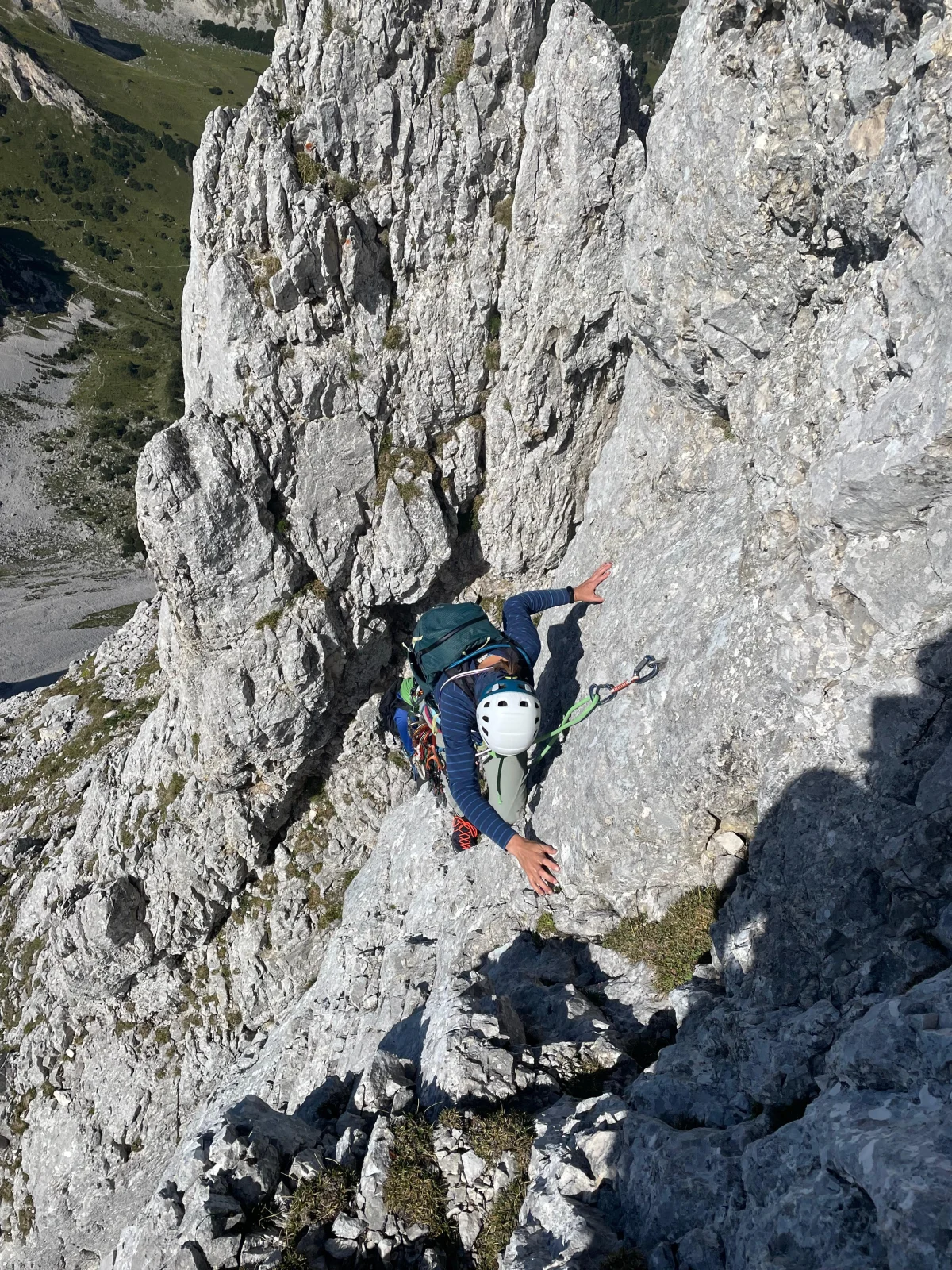Gimpel West Ridge – Climbing Tour with Mountain Guide in the Tannheim Valley: Climber ascending a grey rock wall.