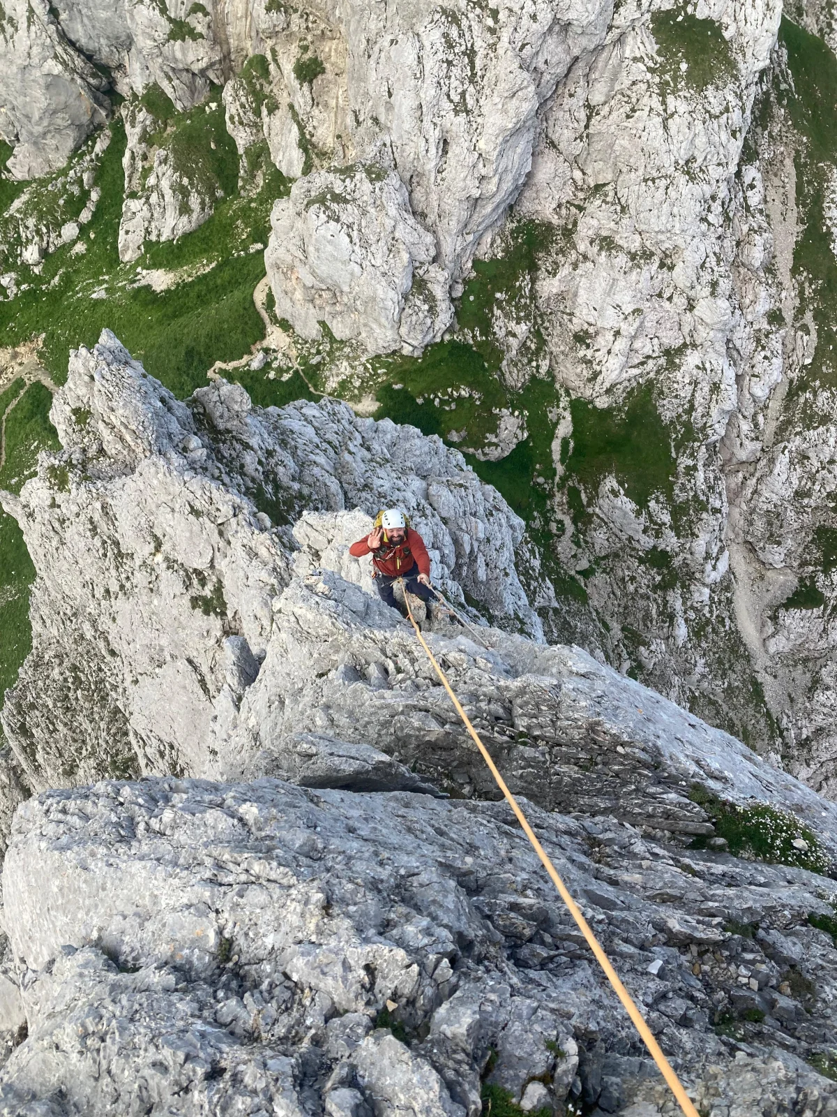 Gimpel West Ridge – Climbing Tour with Mountain Guide in the Tannheim Valley: Following roped climber wearing an orange helmet.