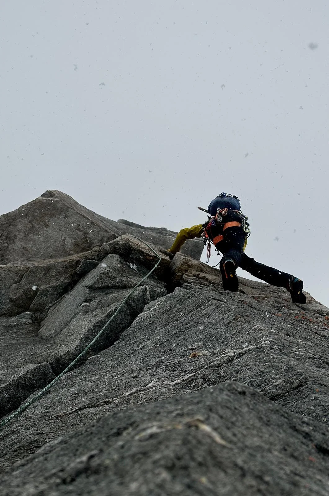 Großvenediger North Ridge with a Mountain Guide: Helmeted climber on a rocky ridge.