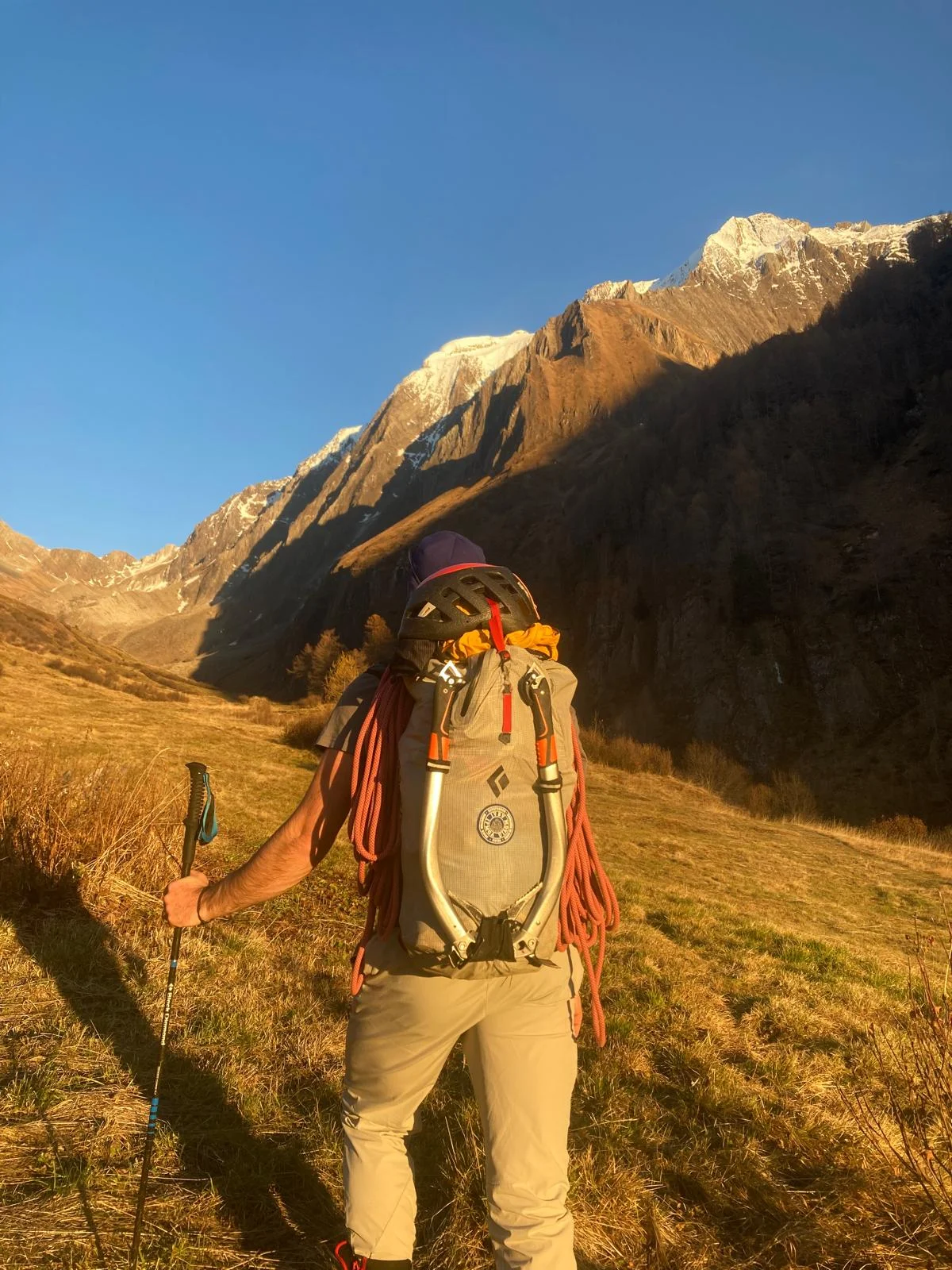 Hochferner North Face with a Mountain Guide: Mountaineer with a backpack on the approach in morning light.