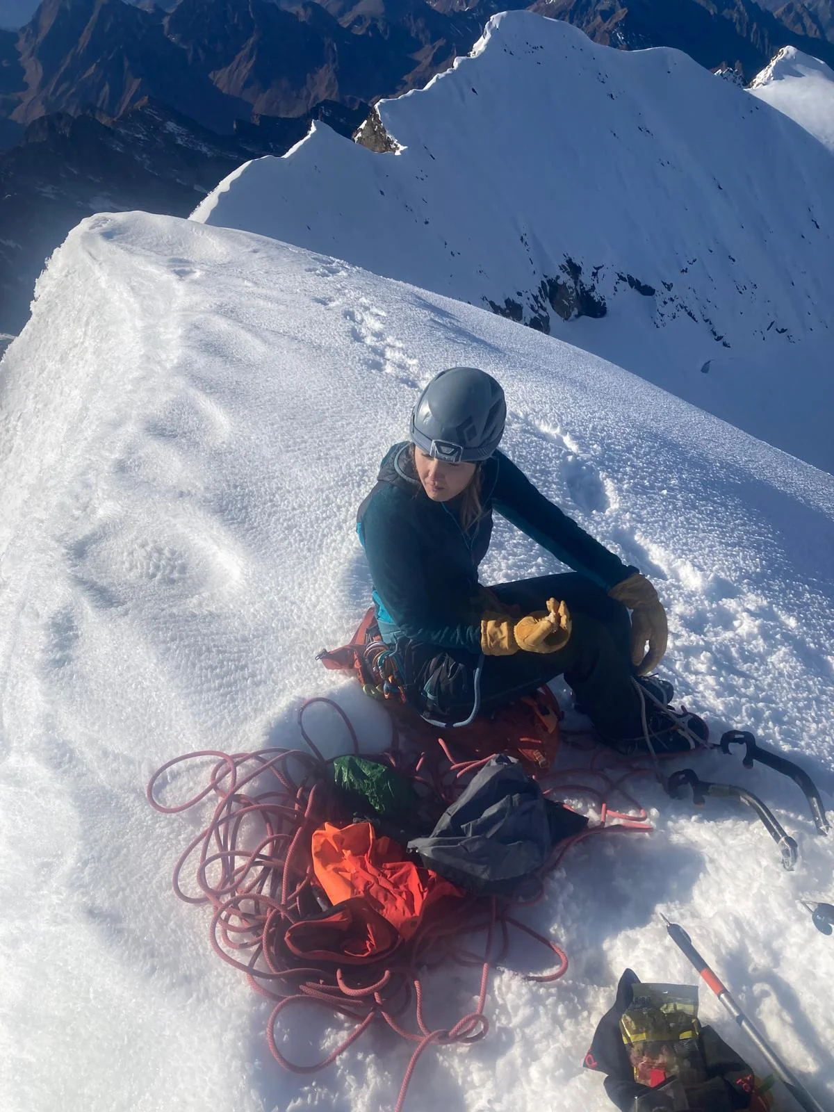 Hochferner North Face with a Mountain Guide: Mountaineer with climbing ropes taking a break in the snow.