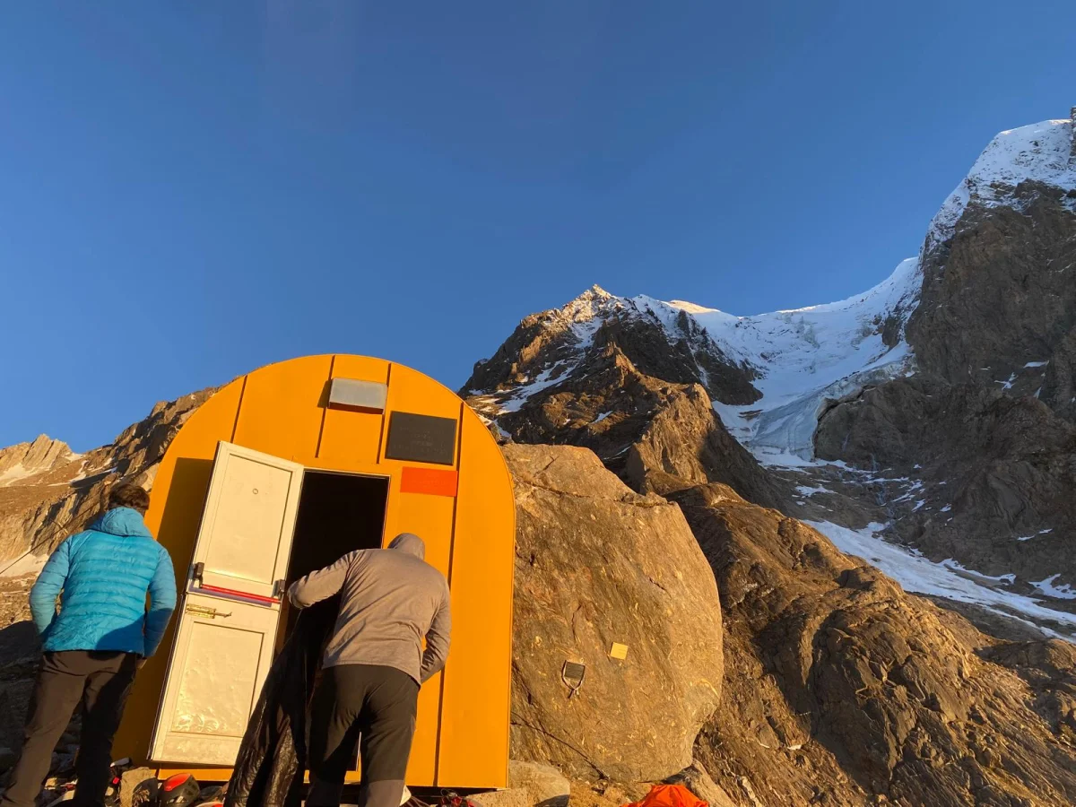 Hochferner North Face with a Mountain Guide: Mountaineers outside an orange bivouac shelter.