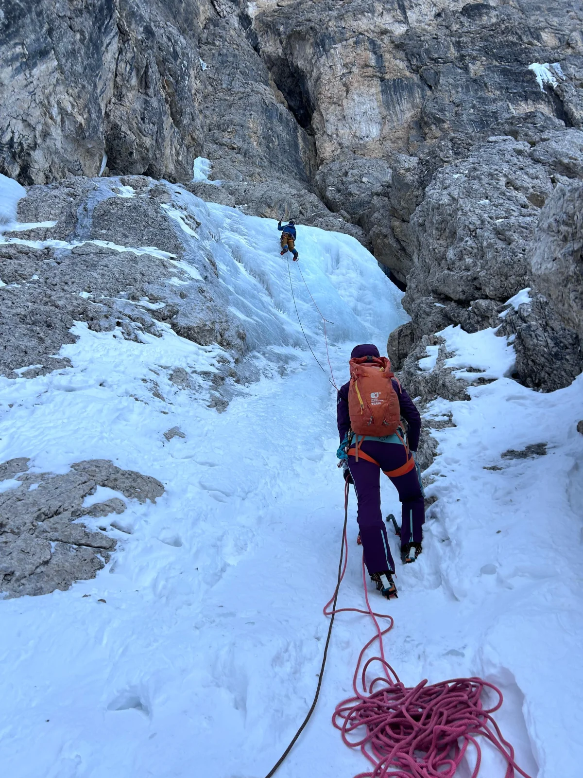Hurschka – Val Mezdi – Guided Mixed Climbing Tour: Ice climber belaying a lead climber at an ice step.
