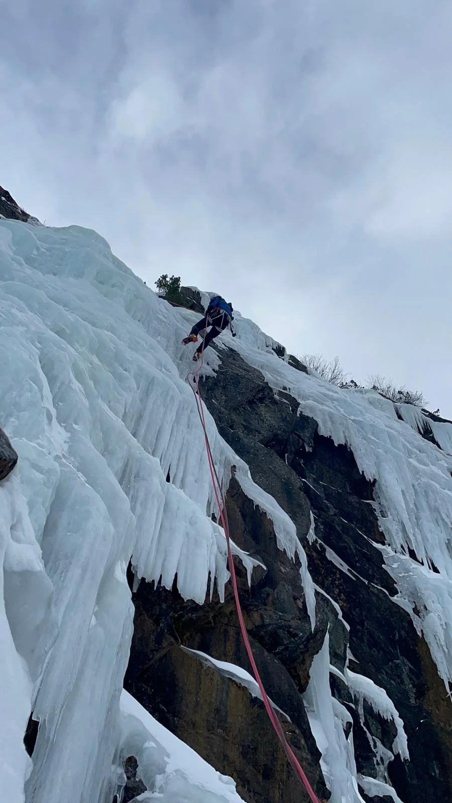 Individual Ice Climbing Course in the Stubai Valley: Icicles and a steep ice wall beneath a cloudy sky.