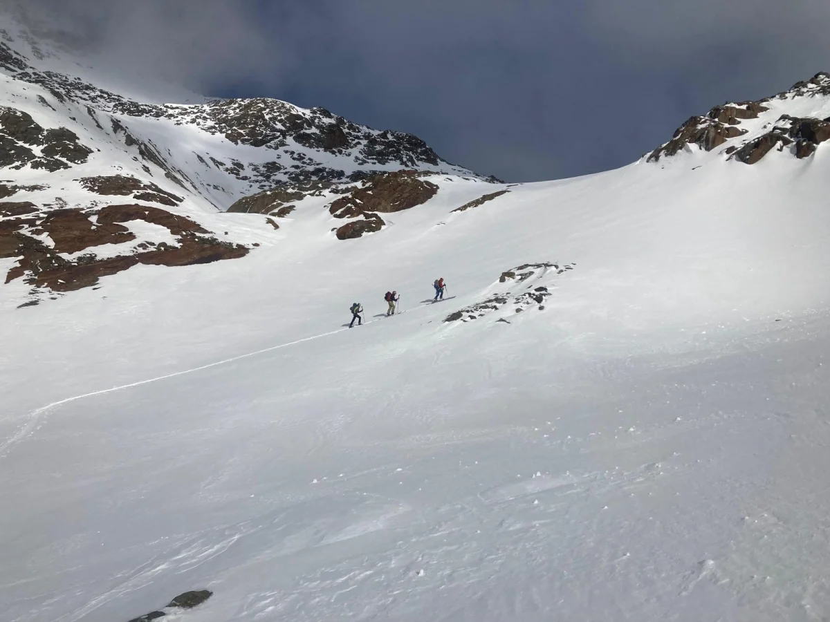 Jakobsleiter – A Special Ski Tour in Stubai: Ski touring group ascending an open snow slope.