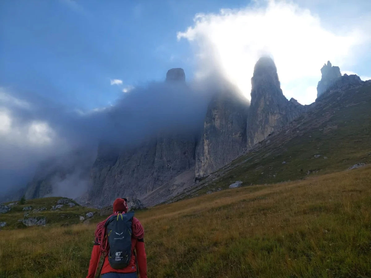 Kasnapoff – Second Sella Tower: Mountaineer in front of distinctive Dolomite rock towers.