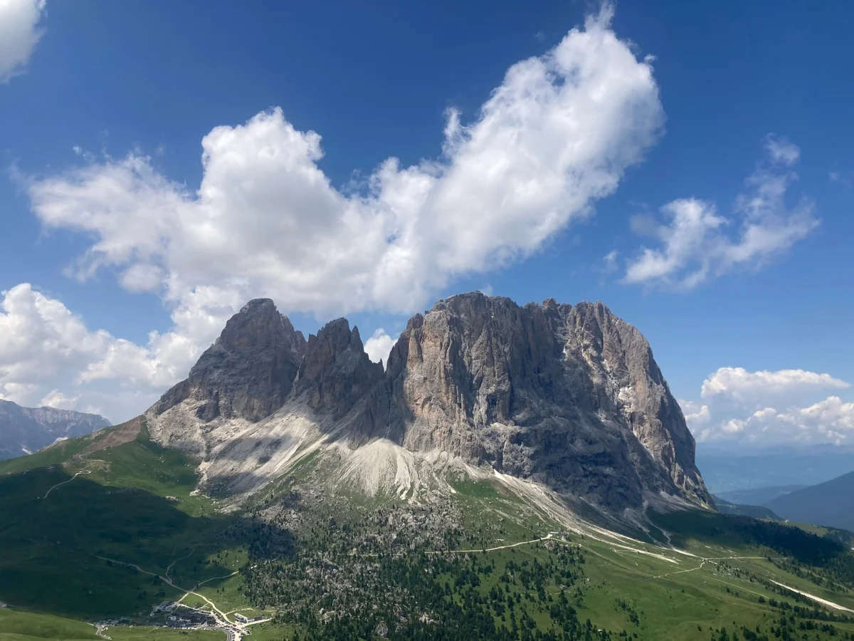 Kasnapoff – Second Sella Tower: Dolomite peaks above green alpine meadows.