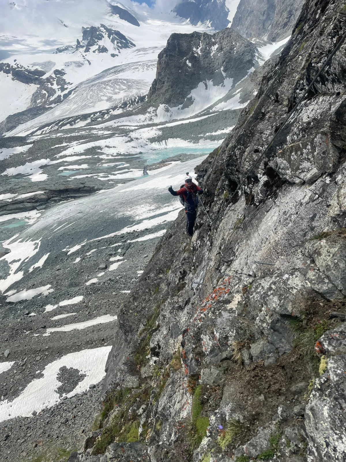 Easy 4,000-Meter Peaks in Saas-Fee: Climber on a rock wall above a glacier.