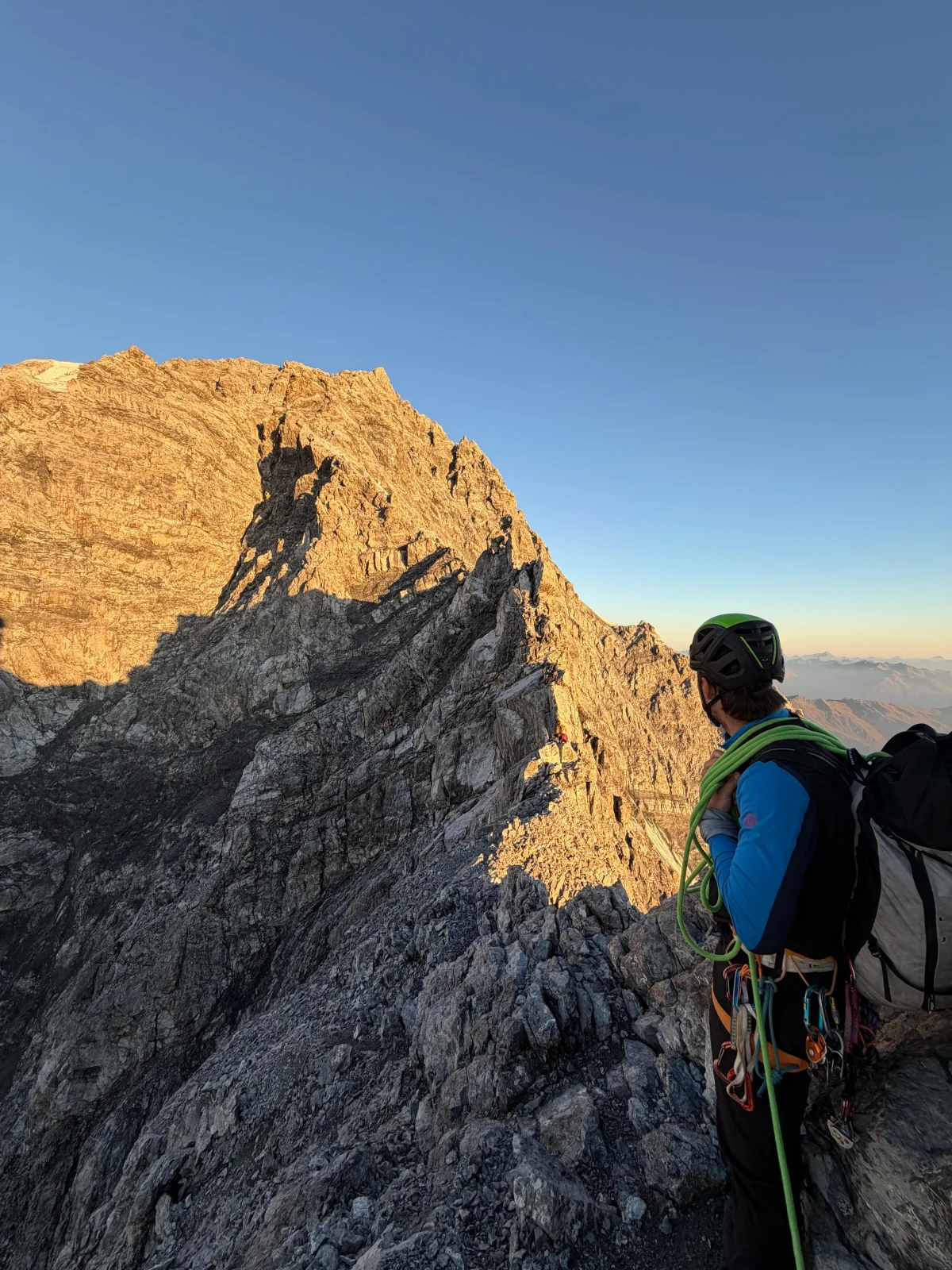 Ortler Hintergrat with a Mountain Guide: Mountaineer in front of a sunlit rocky ridge.