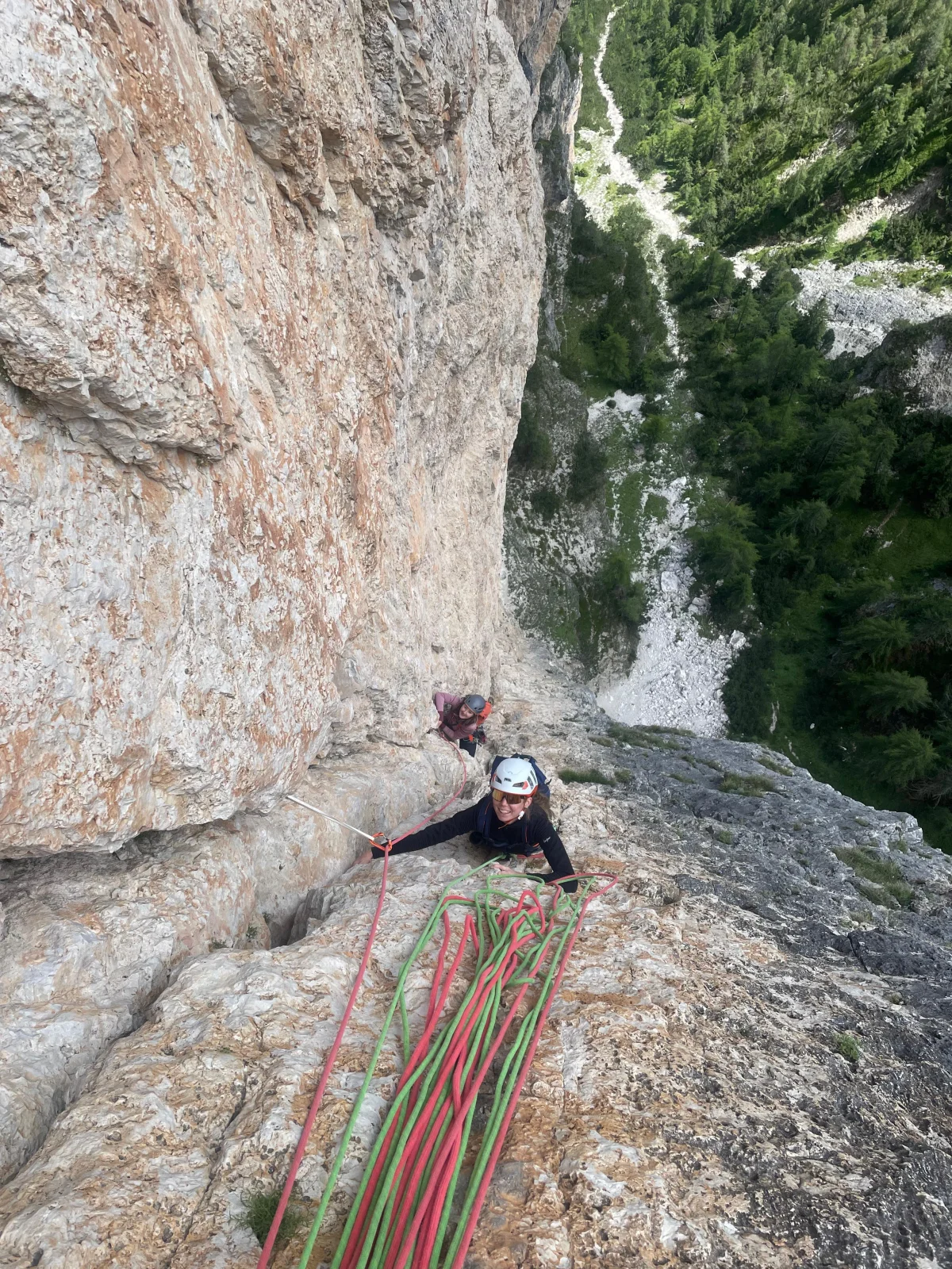 Palfrader an der Geierwand in Toblach – Alpinklettertour in den Dolomiten: Zwei lachende Kletterer mit Helm neben Sicherungsseilen.