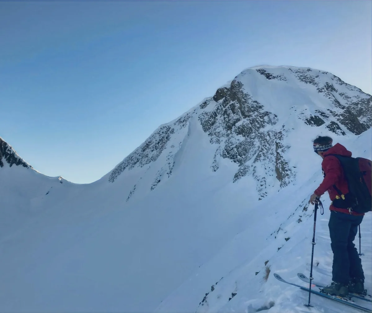 Ski Touring in the Lechtal with a Ski Guide: Ski tourer in front of a snowy mountainside.