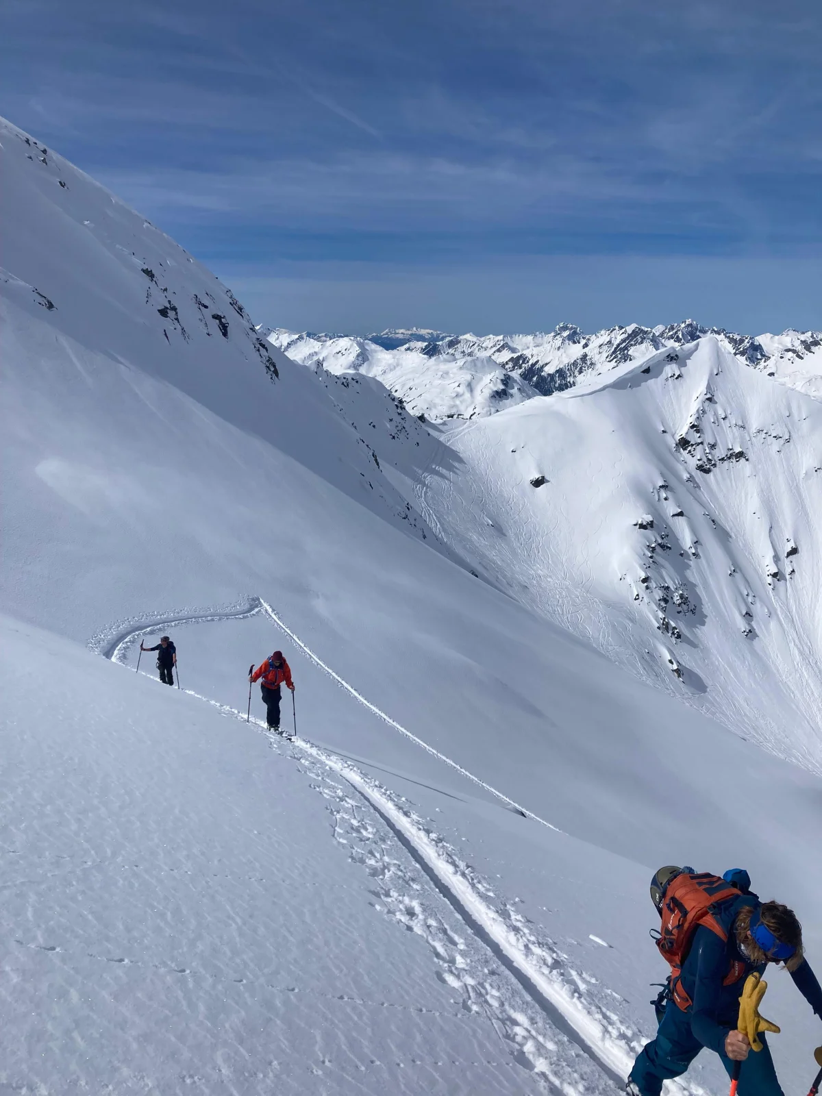 Ski Touring in the Lechtal with a Ski Guide: Ski touring group following a trail across a steep snow slope.
