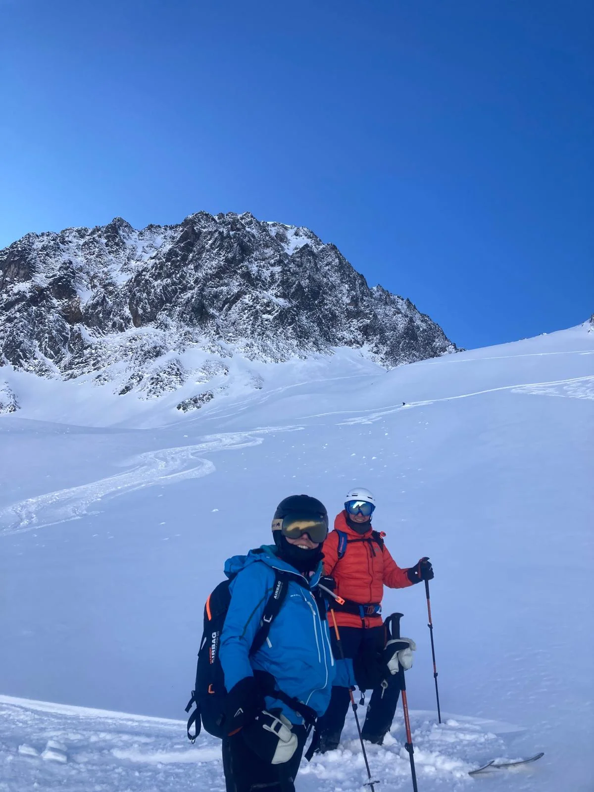 Ski Touring in Sellrain with a Mountain Guide: Two ski tourers with backpacks ascending.