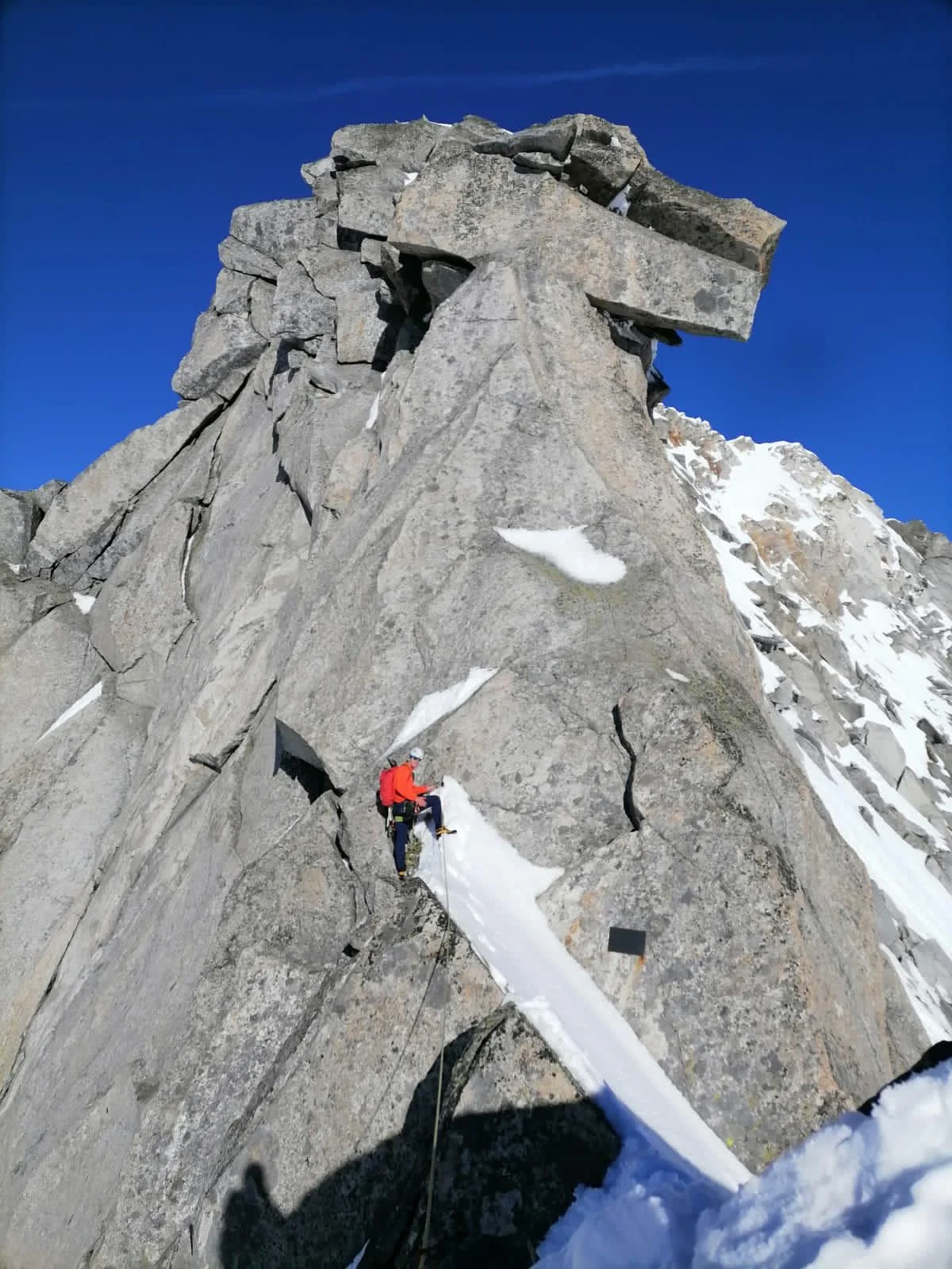 Turnerkamp South Ridge: Roped climber below a large summit boulder.