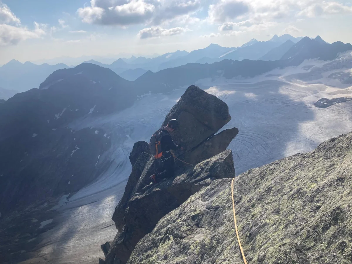 Wilde Leck East Ridge: Roped mountaineer on an exposed rocky ridge.