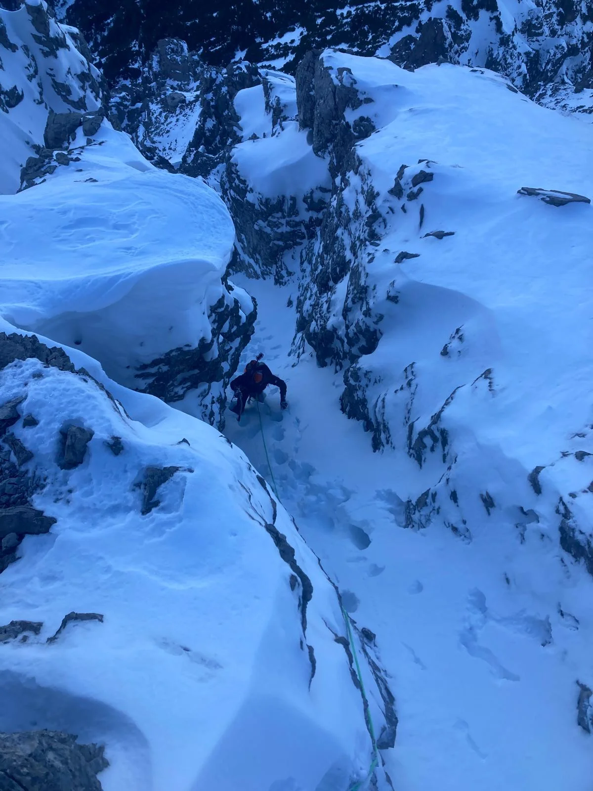 Winter Mountaineering on Thaneller: Tracks in a narrow snowy gully.