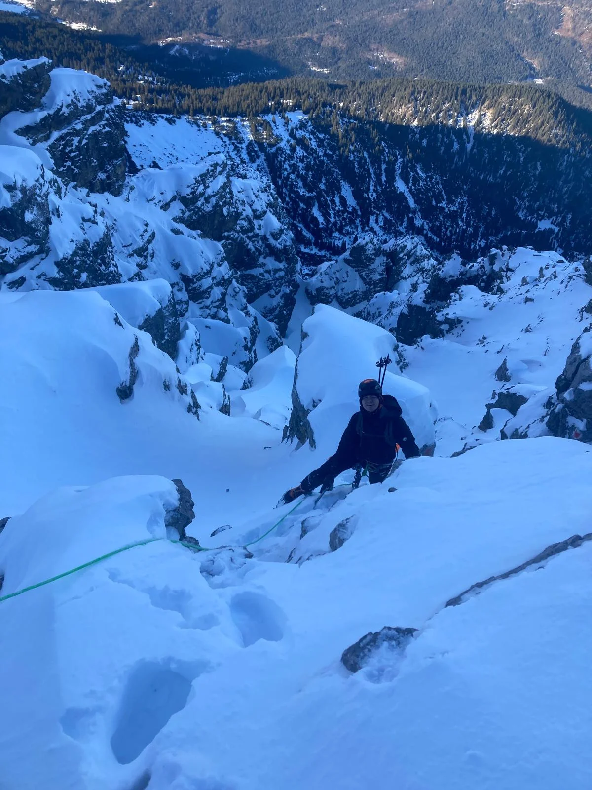 Winter Mountaineering on Thaneller: Mountaineer ascending snowy rocky terrain.